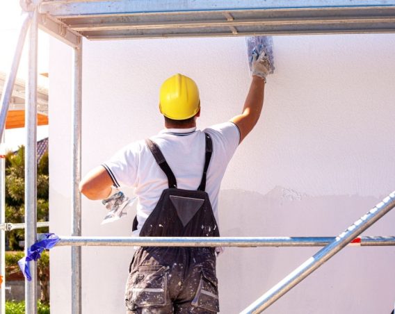 Applying silicone plaster to the wall of the house. Plastering wall.